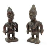 Pair of Yorubu Ibeji carved wood twin figures, each female figure with incised peaked coiffure,