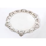 George V silver salver of hexagonal form, with piecrust border and shell and scroll rim,