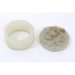 Chinese carved celadon jade hardstone disc carved to the upper face in high relief with prowling