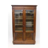 19th century Continental mahogany display cabinet with adjustable shelves enclosed by pair of