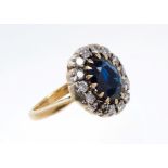 Sapphire and diamond cluster ring with an oval mixed cut blue sapphire measuring approximately 9.