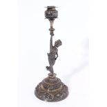 Late 19th century Burmese cast white metal candlestick in the form of a slender female dancer