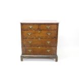 George III oak and fruitwood crossbanded chest of drawers with canted rectangular top and two short