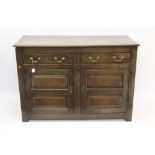 18th century oak dresser base with two frieze drawers over pair of fielded panel cupboard doors,