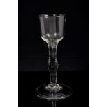 Georgian cordial glass with conical bowl and swollen plain stem on splayed folded foot,