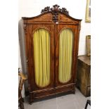19th century Continental mahogany glazed cupboard with floral carved arched cresting and interior