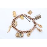 Gold charm bracelet with various gold and yellow metal charms CONDITION REPORT