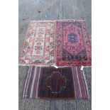 Belouch style rug with aubergine field and broad geometric borders with tassel ends,