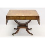 Regency rosewood and brass inlaid sofa table with rounded rectangular drop-leaf top and two flush