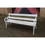 Victorian white painted cast iron bench with wooden slat back and seat between leaf tracery
