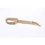 Gold 'belt' bracelet with rope twist and ball links, buckle clasp and tassels to the terminals,