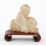 Chinese carved white jade figure of a boy, riding a carp, 4.