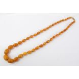 Old amber bead necklace with a string of graduated butterscotch amber beads measuring approximately