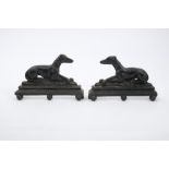Pair of 19th century cast iron fireside models of greyhounds raised on ball feet,