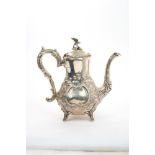 Early Edwardian silver coffee pot of baluster form, with embossed floral decoration,