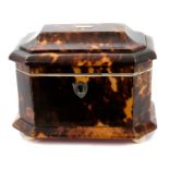 George IV tortoiseshell tea caddy of small size sarcophagus form with hinged lid enclosing cover