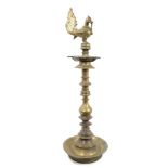 Antique Indian Deccan brass oil lamp with cockerel finial and five spouted reserve on knopped