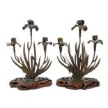 Pair of Japanese Meiji period bronzed three branch candlesticks modelled as water lilies,