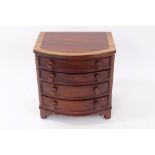Georgian-style miniature mahogany bowfront chest of four long drawers with bun handles on bracket
