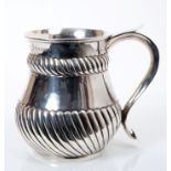 Victorian silver mug of baluster form, with bands of wrythen decoration,
