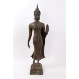 Chinese bronze figure of standing buddha in serene pose on lotus flower socle base - green and
