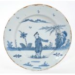18th century English Delft blue and white charger painted in the Chinese taste with a figure in