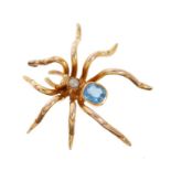 Edwardian novelty gold spider pendant with blue topaz and seed pearl body.