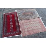 Tekke style rug with single row of nine quartered medallions in geometric borders with tassel ends,