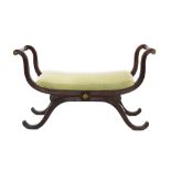 Regency mahogany and brass inlaid window seat with stuffover seat on reeded X-frame supports,