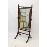 Regency mahogany cheval mirror with rectangular swing plate within ring-turned frame,