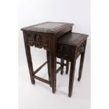 20th century nest of two Chinese carved hardwood occasional tables with figure and foliate