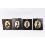 Group of four early 19th century silhouette portrait miniatures each in glazed papier maché frame