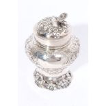 George III silver tea caddy of inverted baluster form, with embossed floral and scroll decoration,