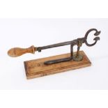 19th Century bronze and steel sugar cutter on wooden base