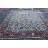 Good antique Heriz carpet with rows of stylised flower heads on cream ground,