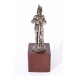 Silver model of a Kentish Fusilier Soldier leaning on his rifle on a mahogany plinth (Lion passant