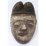 Good early Yoruba polychrome painted mask with elaborate coiffure, 18cm high.