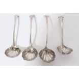 Set of four Georgian silver Onslow pattern sauce ladles with shell bowls and engraved armorial