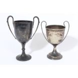 Edwardian silver trophy cup with leaf-mounted twin handles, on a tall pedestal foot,