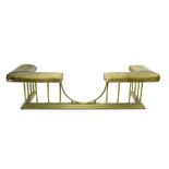 Brass and leather upholstered club fender of typical form,