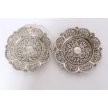 Pair of late 19th / early 20th century Indian white metal dishes of flower head form with embossed