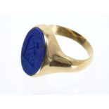 Gold signet ring with an oval lapis lazuli bezel with intaglio crest.