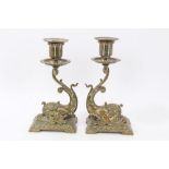 Pair of late 19th century brass desk candlesticks each with stylised dolphin support with integral