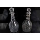 Two George III ring neck decanters with moulded target stoppers and engraved ribbon swags and