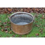 Large copper vessel with everted rim and twin loop handles,