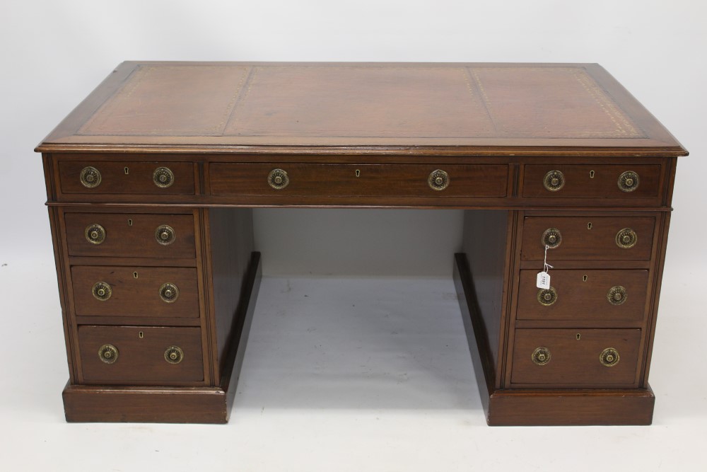 Late 19th / early 20th century mahogany pedestal desk with tooled red leather inset top and nine