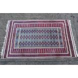 Belouch rug, cream ground with three rows of lozenge medallions in geometric borders,