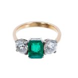 Fine Emerald and diamond three stone ring, the central step cut emerald weighing 1.