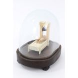 Miniature prisoner of war-style ivory guillotine under glass dome,