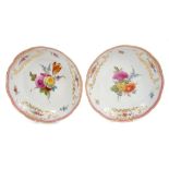 Pair 18th century Meissen dishes with polychrome painted floral sprays and gilt moulded cartouches